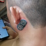 Dice behind ears tattoo